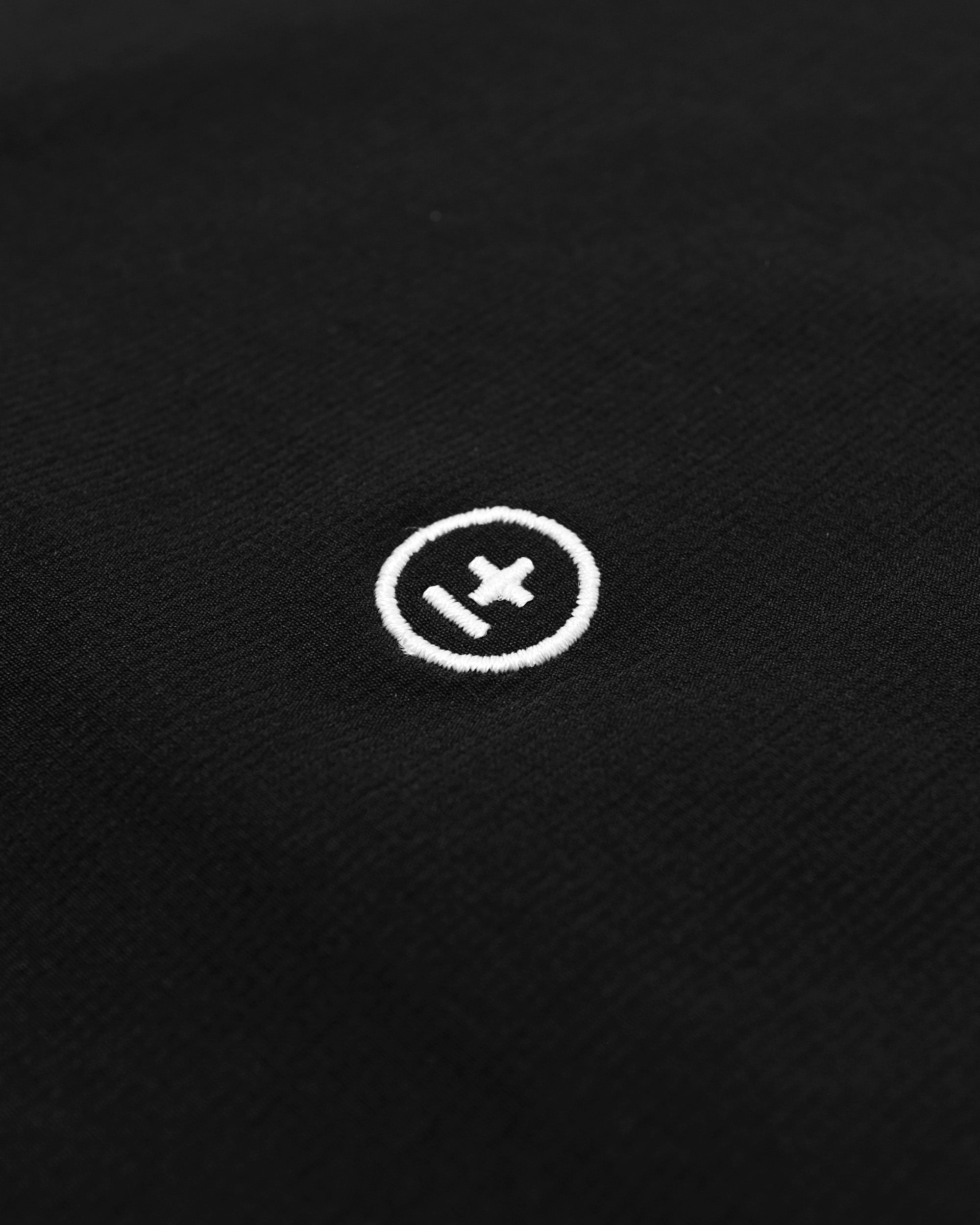 Close-up of a white logo on a black textured background