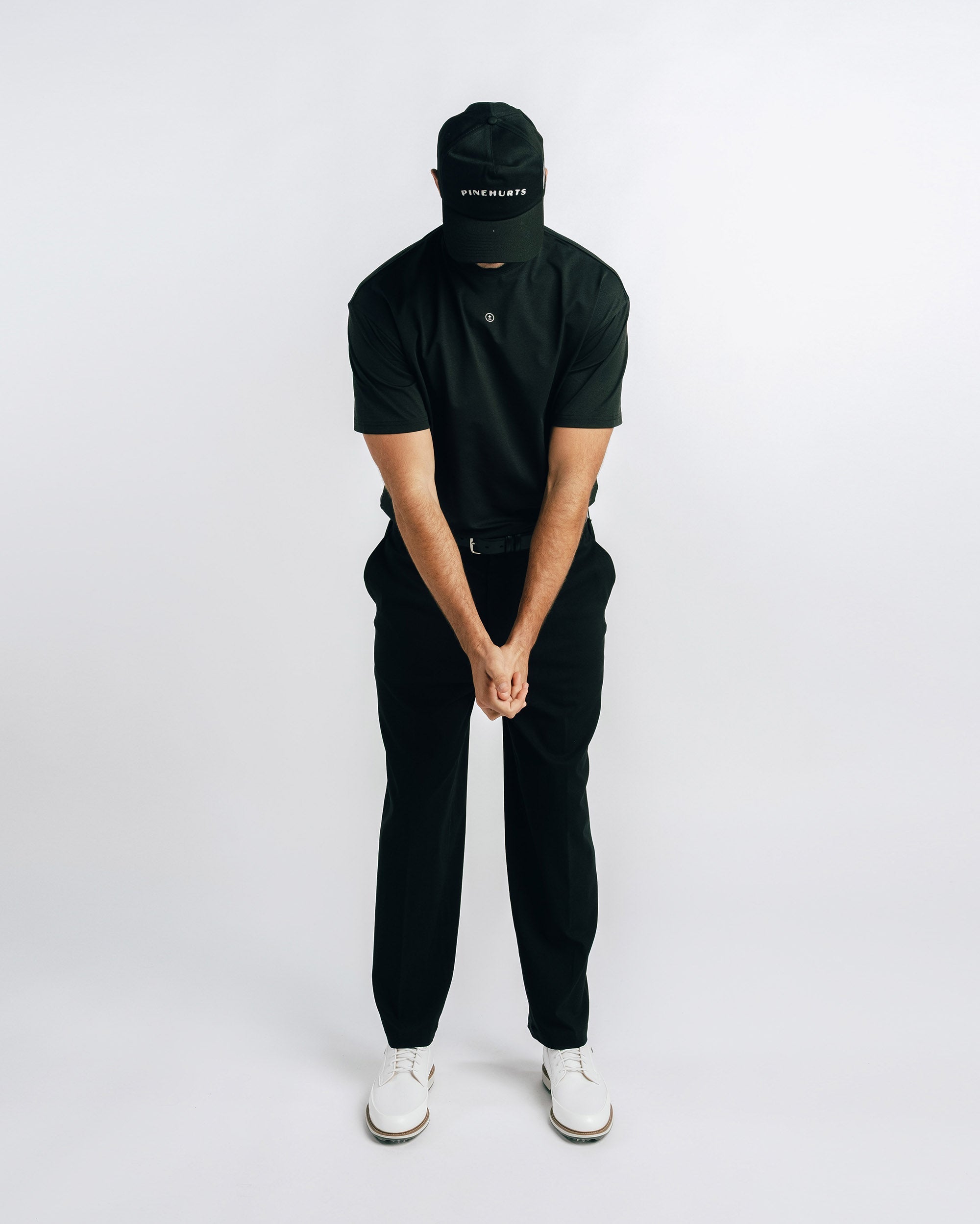 Person wearing a black outfit with a white background