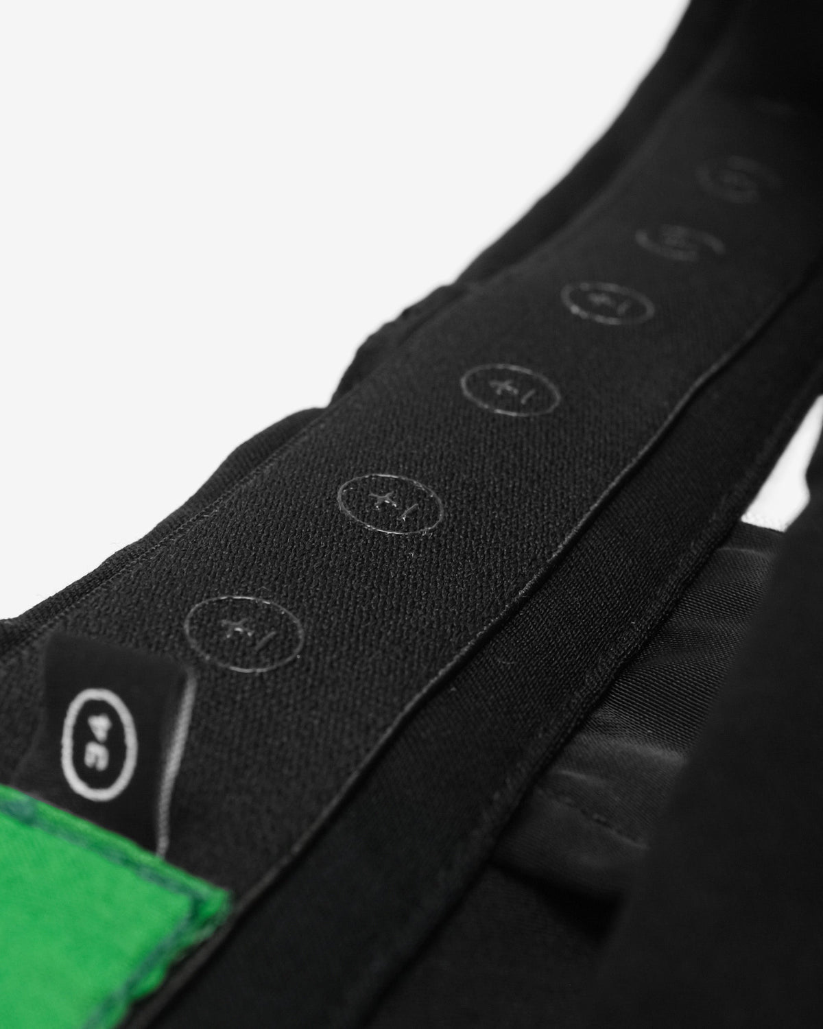 Close-up of a black electronic device with control buttons on a white background