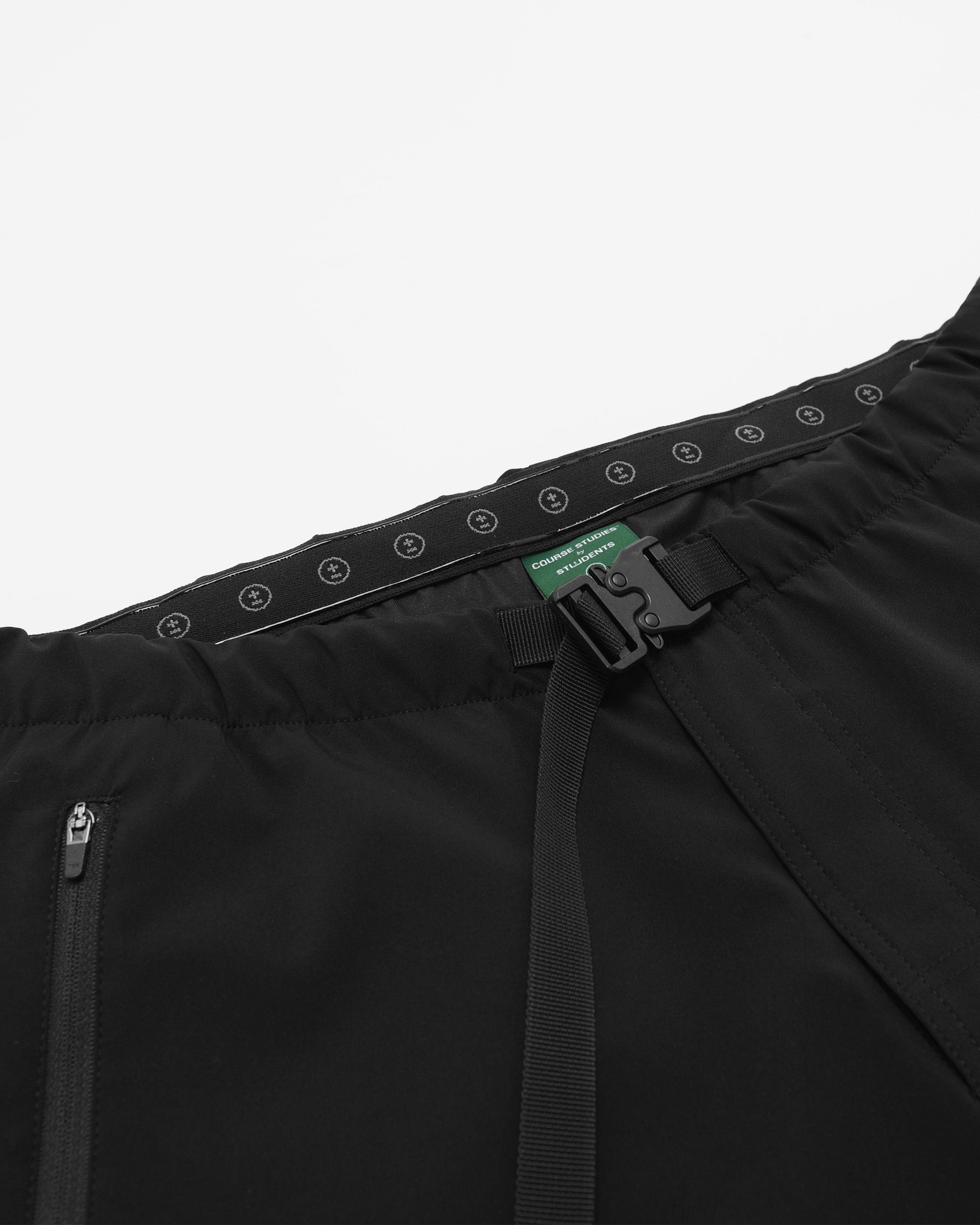 Close-up of a black jacket with a belt and visible brand logo on a white background