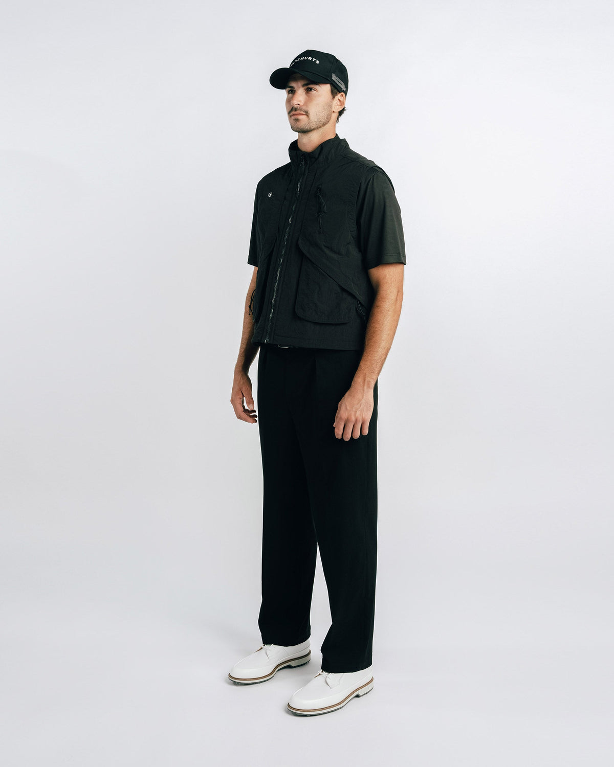Man wearing a black outfit with a white background