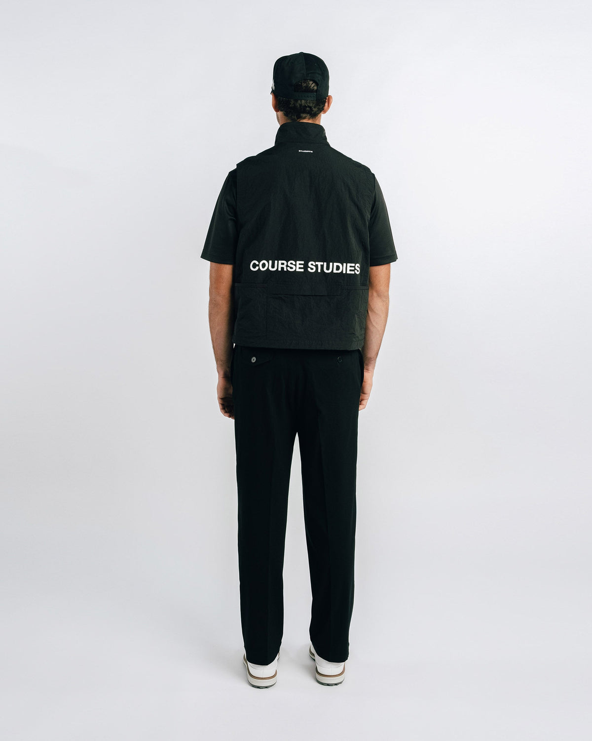 Person wearing a black jacket with 'Course Studies' branding on a white background