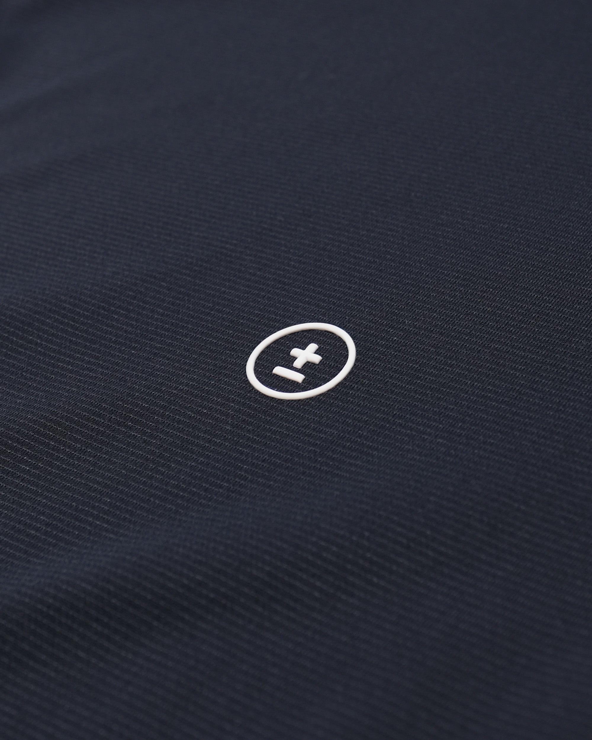Navy blue fabric with a white logo in the center