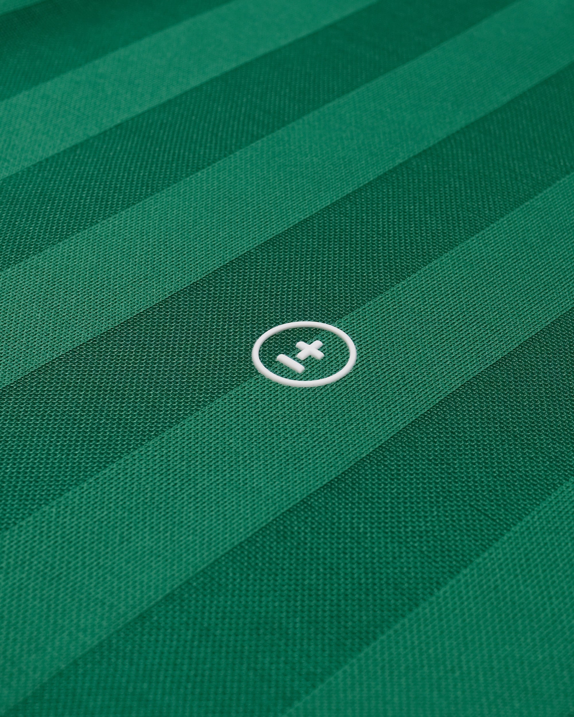 Close-up of green fabric with a logo in the center